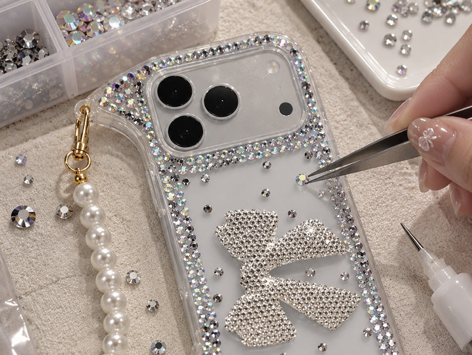 Hand decorating an accessory with rhinestones